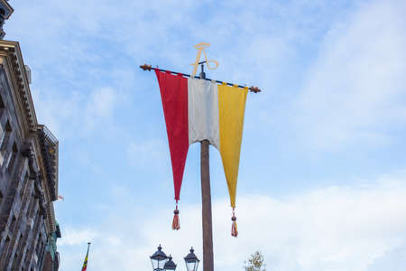 Dutch Flag of traditional festival Named Carnaval sHertogenbosch, Oeteldonk in the blue sky,...