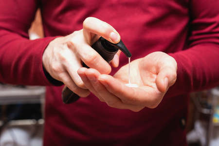 Health beauty and skin care concept. Closeup young bearded man with beard soap or shampoo on his hand for washing beard, cleaning conceptの写真素材
