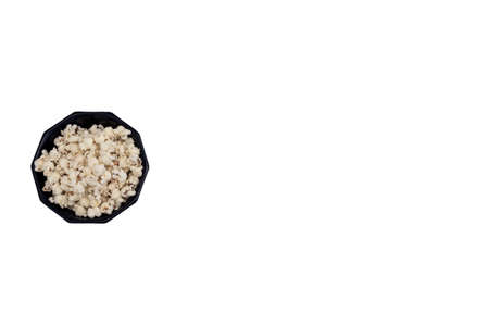 fresh popcorn in bowl top view isolated on white background, space for text healthy snackの写真素材