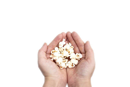 Hand holding popcorn isolated on the white background, space for textの写真素材