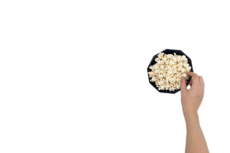 Hand holding popcorn isolated on the white background, space for textの写真素材