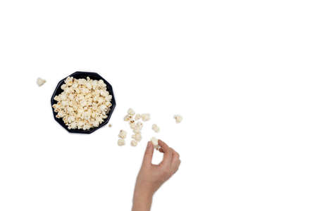 Hand holding popcorn isolated on the white background, space for textの写真素材