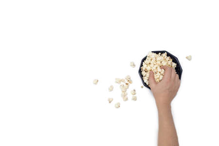 Hand holding popcorn isolated on the white background, space for textの写真素材