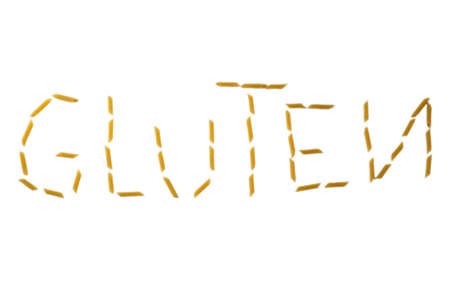 gluten word made with pasta penne isolated on white backgroundの写真素材