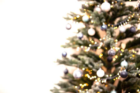 Christmas tree blurred and defocused light background, decorated with christmas decoration bokeh colorful shining lightsの写真素材