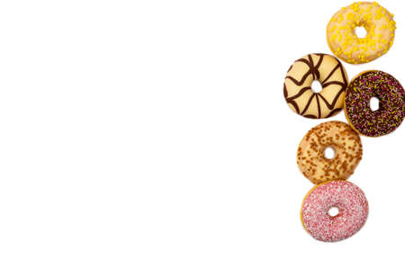 various colored delicious donuts on white background, space for textの写真素材
