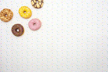 Various colored delicious donuts with festive star background Celebration concept. Top view space for text backgroundの写真素材