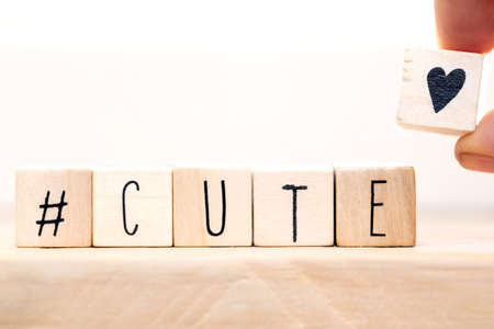 Wooden Cubes with hashtag the word cute and a little heart, social media conceptの写真素材
