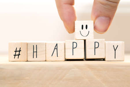 Wooden cubes with a Hashtag and the word Happy, smile and heart, social media concept background...