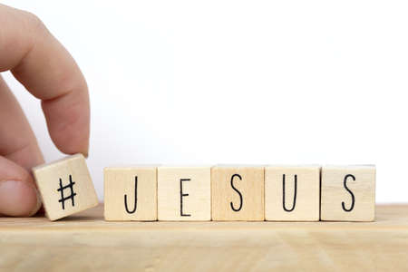 Wooden cubes with a hashtag and the word Jesus, social media concept God is love concept text backgroundの写真素材