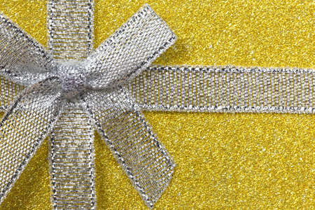 Sparkling gift box or present with bow ribbon on magic Background with glitters Copy space for...