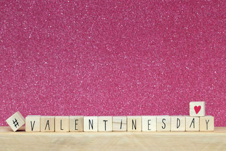Wooden cubes with hashtag and the word valentines day, social media concept background