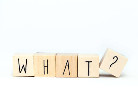 Wooden cubes with the word What and a question mark isolated on white background close-up