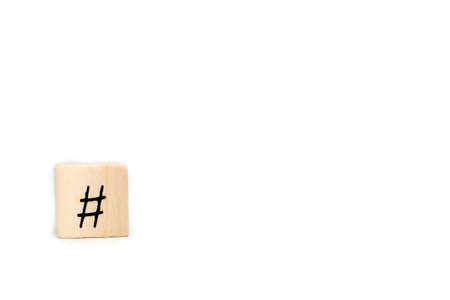 Wooden cube with hashtag isolated on white background, social media concept with space for textの写真素材