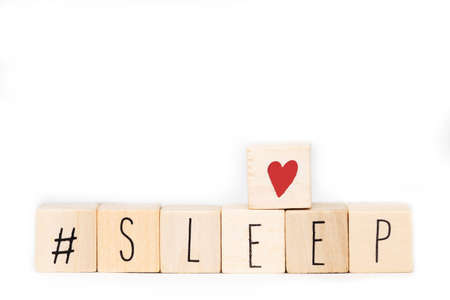Wooden cubes with a Hashtag and the word Sleep isolated on white background, social media concept space for text close-upの写真素材