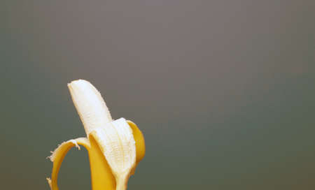 Peeled yellow banana fruit near colorful background space for text, healthy concept colorfulの写真素材