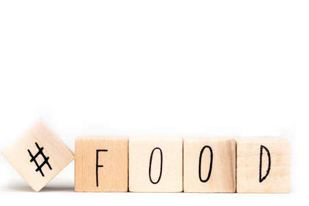 Wooden cubes with a hashtag and the word food, social media concept isolated on white background closeの写真素材