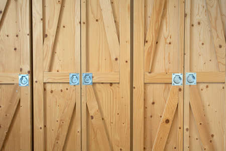 Modern wooden brown doors closeup storage, retro modern interior background texture vintageの写真素材