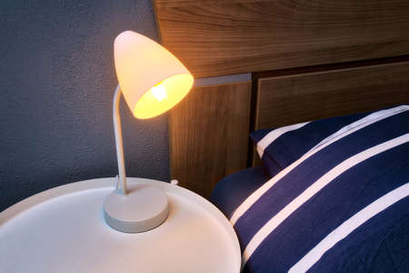 Modern Night Lamp next to bed retro design, lamp on night table close-up