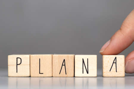 Wooden cube with PLAN A text on grey background. Goals, success, strategy, solution and business concepts close-upの写真素材