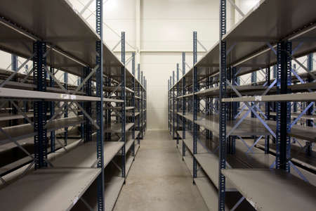 huge warehouse with empty racks inside for storage modern design, metal shelves for distribution...