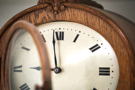 Close up of vintage antique brown handmade clock with roman numbers macro photography
