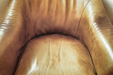 Detail of an old brown leather chair, Leather chair close-up. Leather texture material background