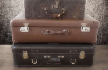 Old Vintage Suitcase in retro room on the floor, three piled suitcases backgroundの写真素材
