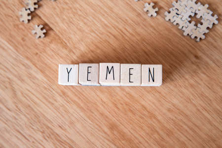 The Country Yemen written on wooden cubes on wooden background, Country in the Middle East textureの写真素材