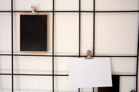 Blank postcards on Nordic style Metal mesh grids picture postcards wall frame, Storage rack hanging in modern home on wall decoration interiorの写真素材