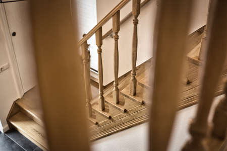 Wooden Railing of an luxury antique staircase, woodwork elements macro photograpy, retro design beautiful interior of a modern houseの写真素材