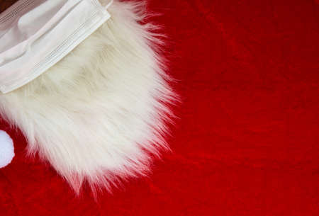 Christmas Santa Claus white furry beard on red fabric, Christmas concept, background texture