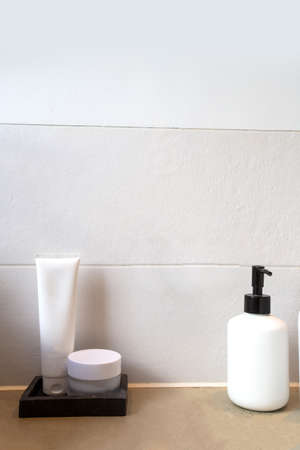 collection of various blank and white beauty hygiene bottle in modern bathroom near white sink,の写真素材