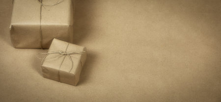 two gift package wrapped with plain brown paper and rope and brown paper background texture, retro gift box. present conceptの写真素材