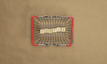 Reopen store concept after the coronavirus pandemic. Wooden blocks with text reopen store top view...