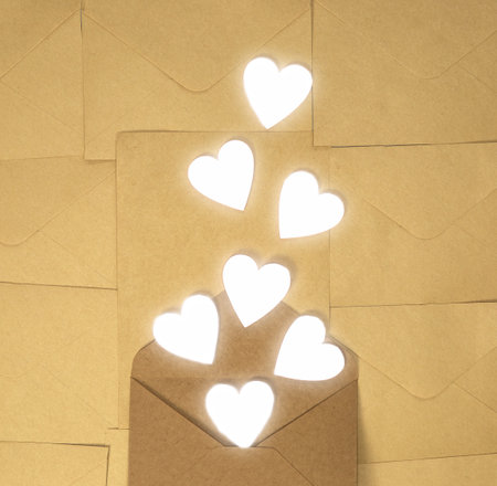 Craft brown paper envelope with white hearts, Valentines Day, greeting card concept top view background, copy spaceの写真素材