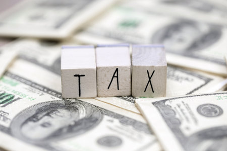 Tax text with hundred dollar bills background, business, financial and tax time conceptの写真素材