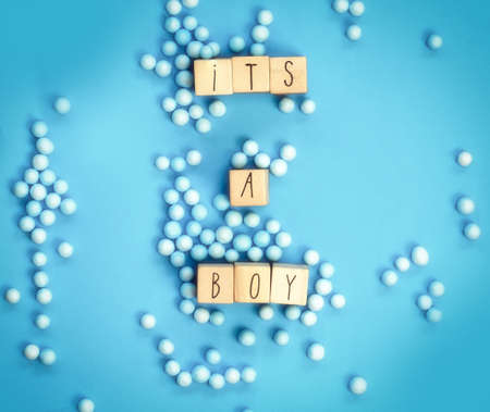 Its a Boy text written with wooden cubes with pastel blue background, Baby Shower or Nursery...