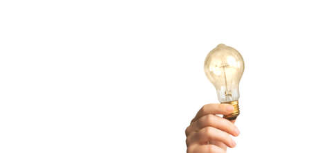 Hand holding glowing light bulb, finding innovative solutions and creative ideas, being unique,...