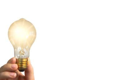 Hand holding glowing light bulb, finding innovative solutions and creative ideas, being unique,...