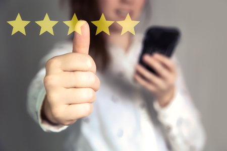 Customer Experience Concept. Woman hand showing on five star excellent rating on background, copy space Female with thumbs upの写真素材