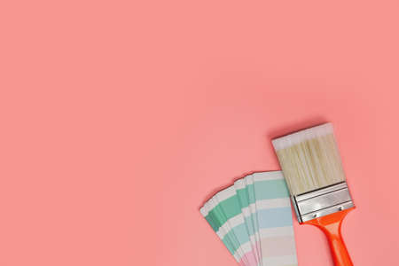 Paintbrush with palette for painting sample with pastel colors on pink background top view, Flat...