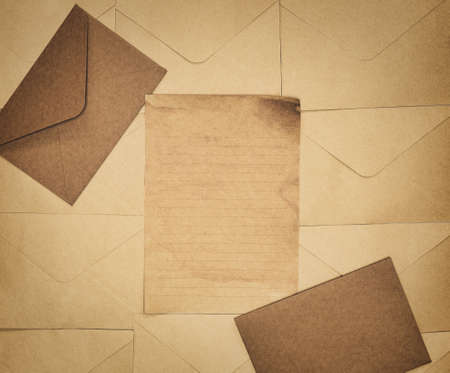 Vintage old brown envelope and paper background texture top view, Flat lay copy space, business, education, antique, rustic conceptの写真素材