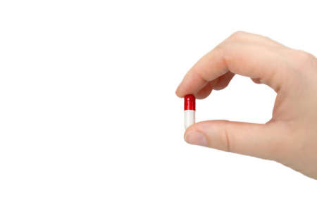 Person holding Medical pill,capsule,Vitamin,medication,medicine isolated on white background in handの写真素材