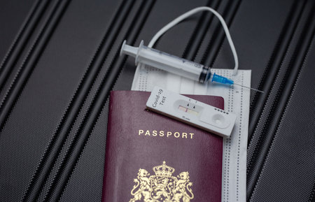 COVID-19, travel and lockdown concept,Passport with Covid-19 rapid test and syringe for vaccination...