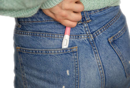 Young woman and pregnancy test with blank copy space for positive or negative result composite...