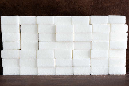 White sugar cubes composition of Brick wall, pile of sugar, unhealthy food, ingredient, candy and...