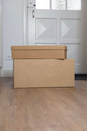 Stack of Cardboard boxes blank in the Hallway of new home on the floor. Moving, storage or delivery...