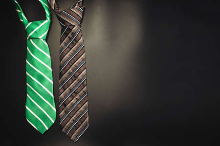 Necktie on dark shadow black background with copy space, International Mens Day and Fathers Day concept.の写真素材