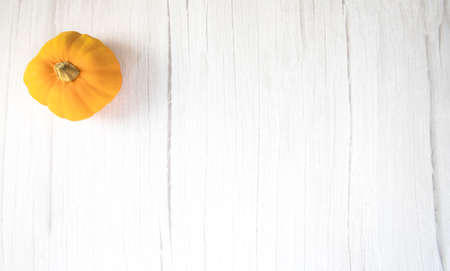 Orange pumkin on white wooden background texture top view with copy space, Halloween,October,Autumn and food conceptの写真素材